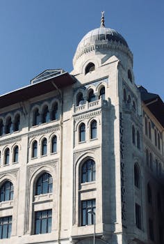 Elegant Ottoman architecture of Legacy Ottoman Hotel in Istanbul under a clear blue sky.