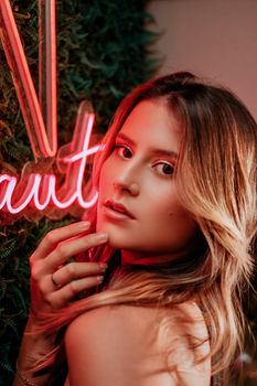 Striking portrait of a woman illuminated by vibrant neon lights, creating a modern aesthetic.