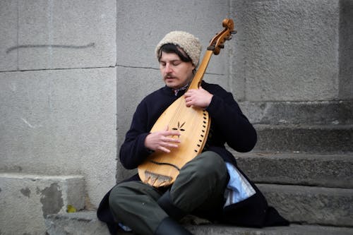 Man Playing Lute on Urban Steps