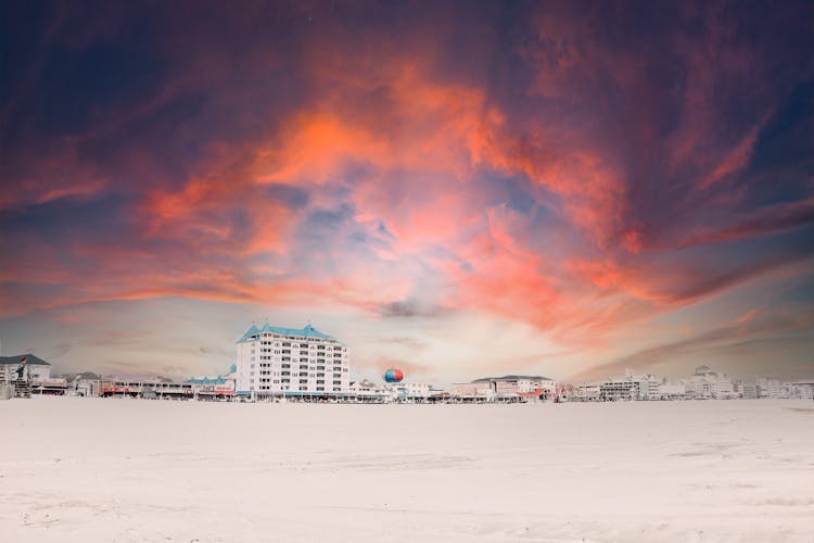 Majestic Cloud Over Buildings And Beach