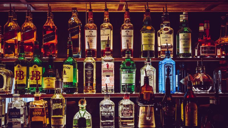 Assortment of hemp beverages legal for retail sale arranged on a wooden bar counter