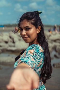 Portrait of a young woman on Cox's Bazar beach in Bangladesh, sunny day.