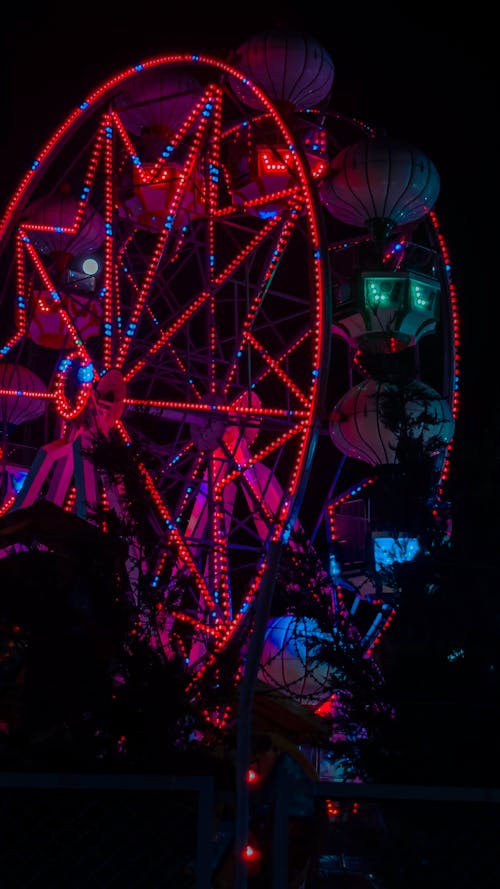 Illuminated Ferris Wheel in Night Sky