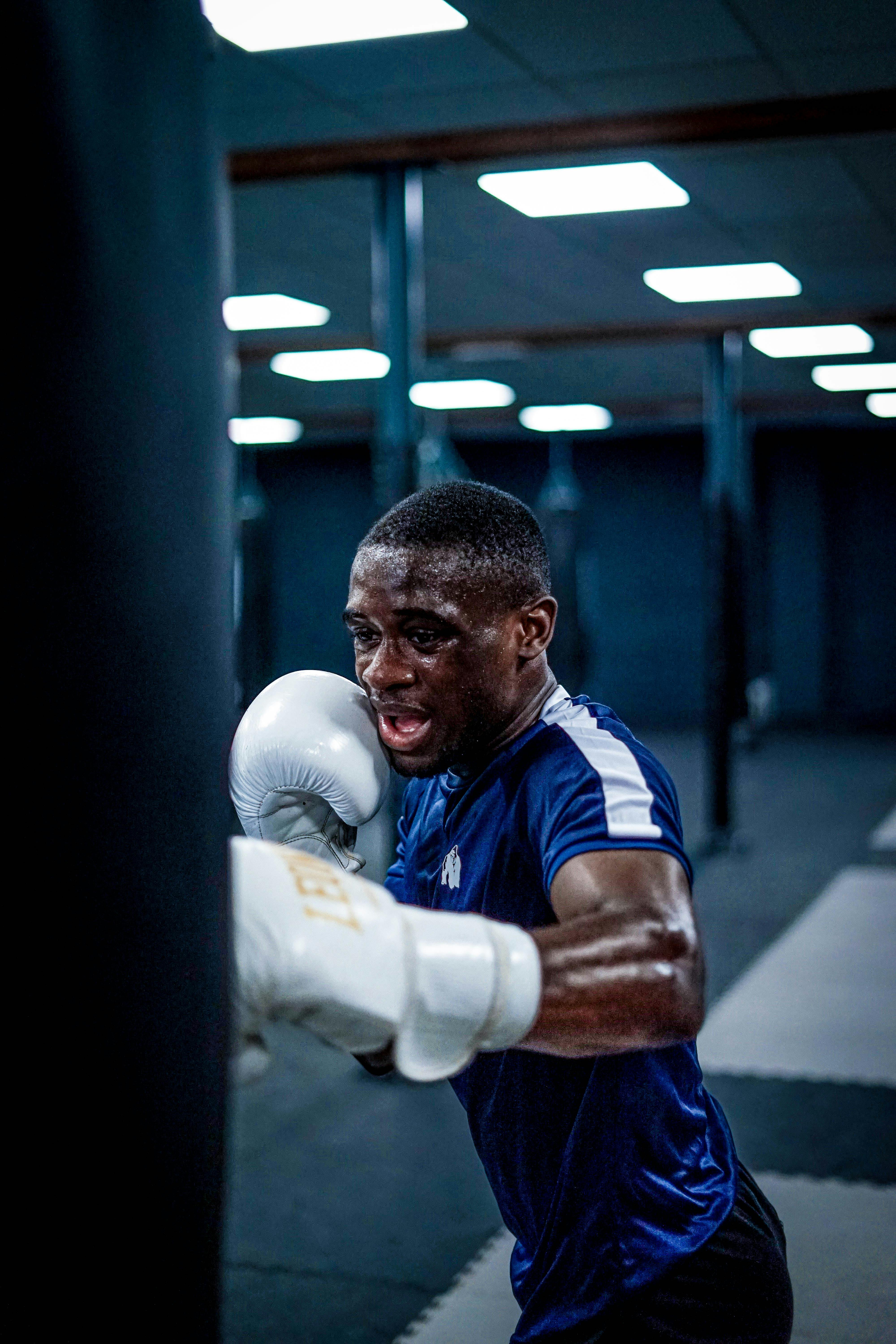 A Man Punching a Heavy Bag · Free Stock Photo