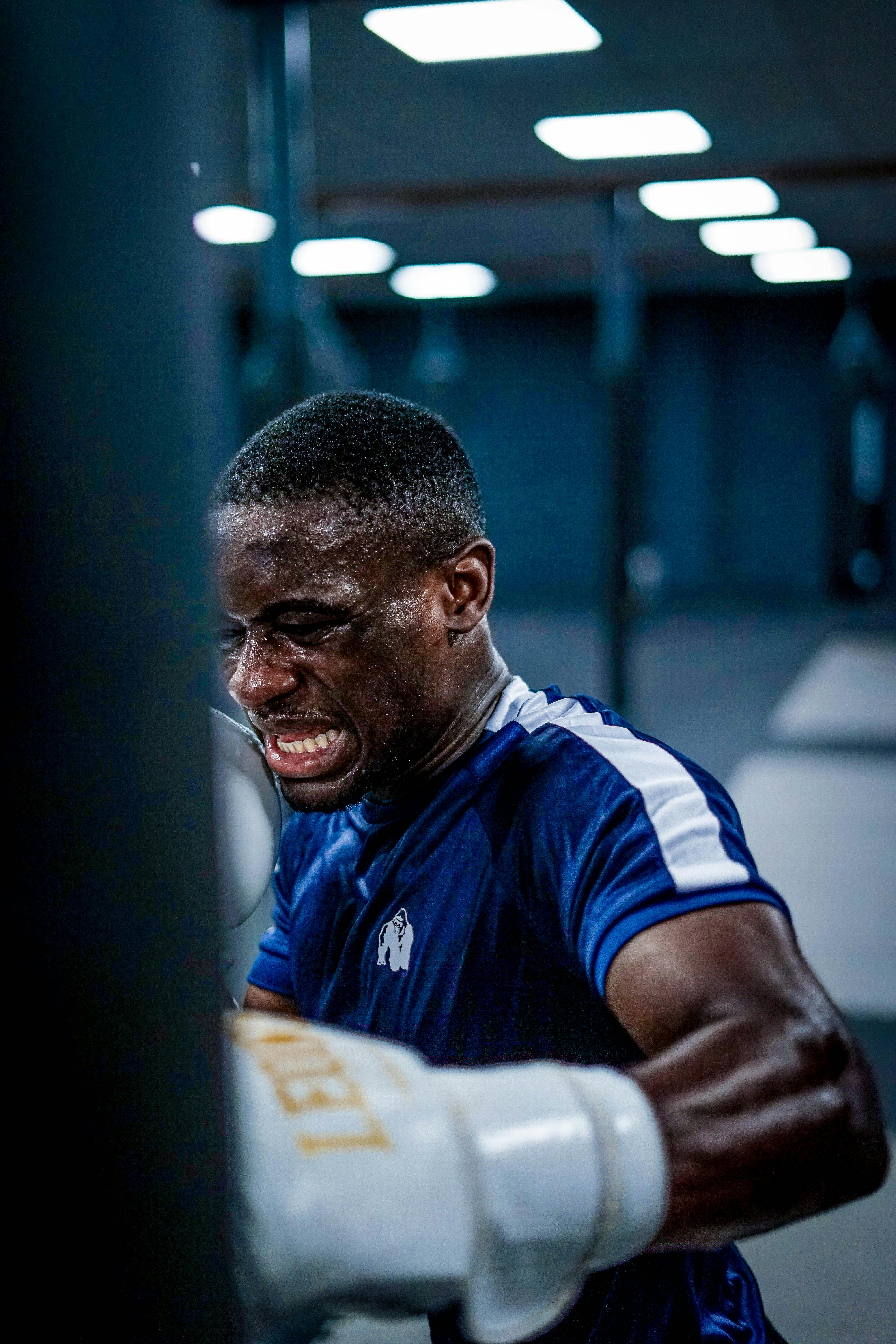 A Boxer Punching a Heavy Bag · Free Stock Photo
