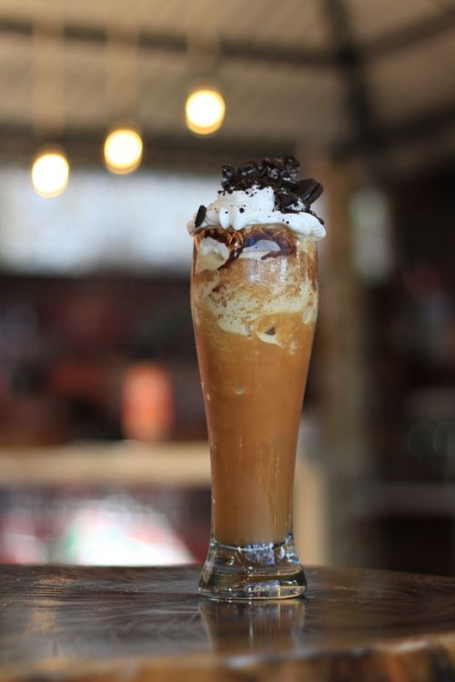 Free A refreshing iced coffee topped with whipped cream and chocolate chips in a tall glass. Stock Photo