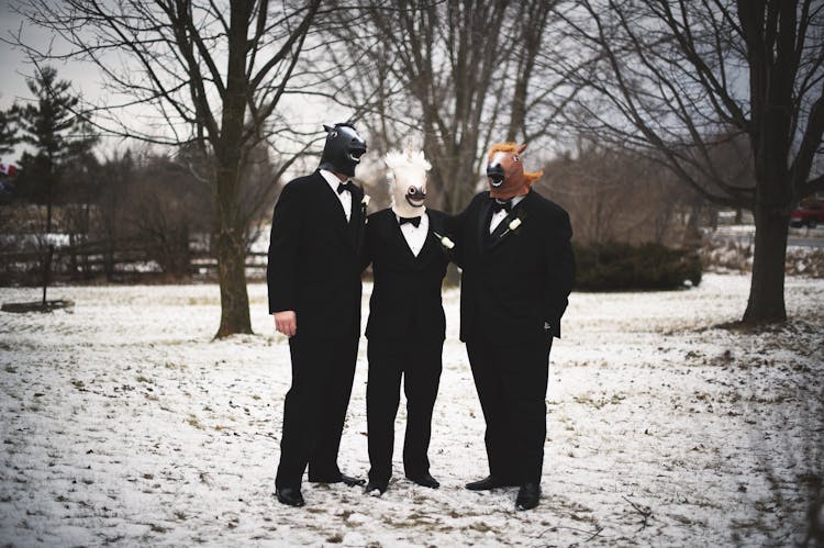 Men In Black Suits Wearing Head Masks