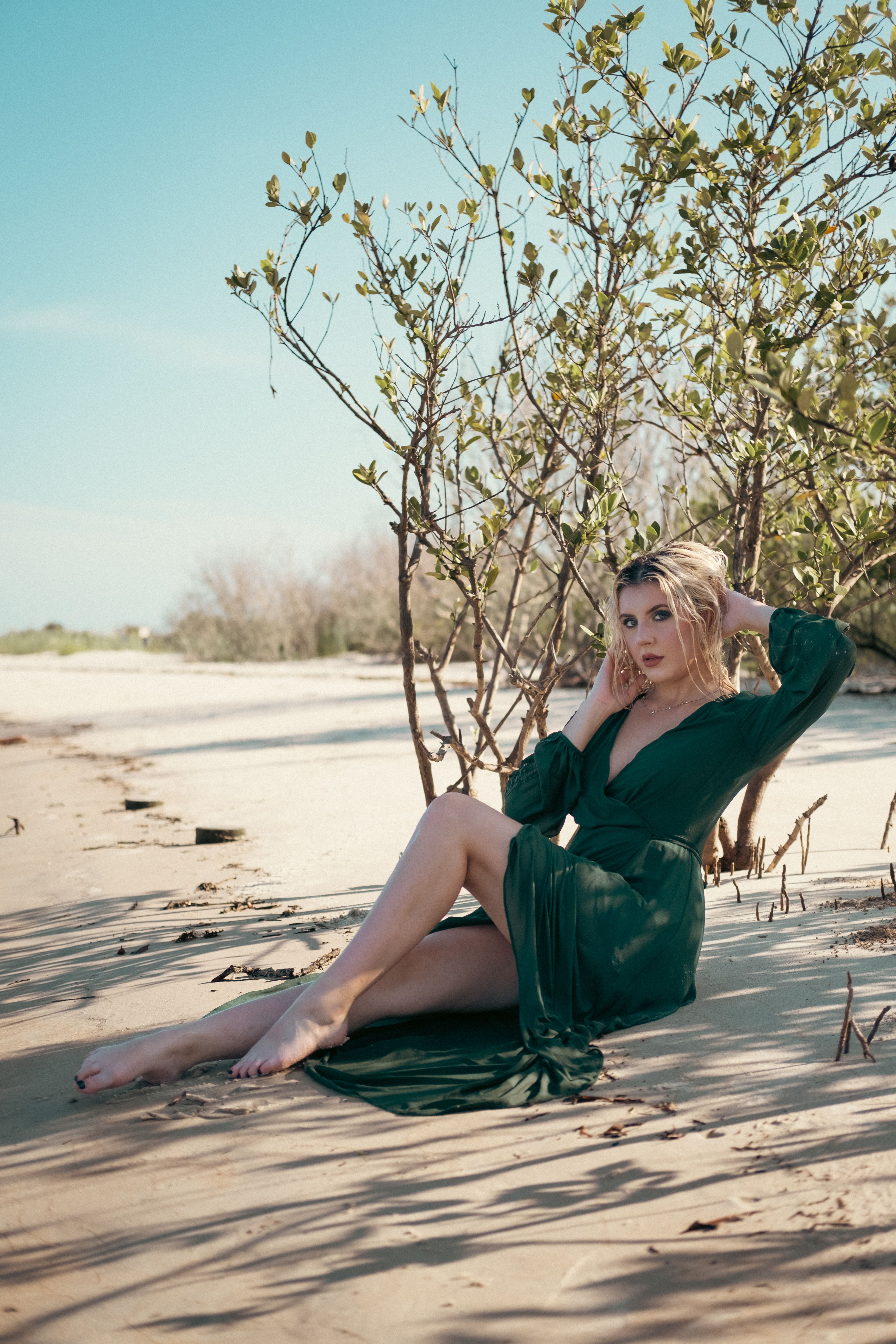 Woman in Green Dress Sitting on the Beach Sand · Free Stock Photo
