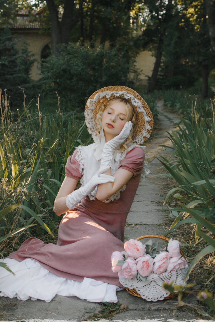 Portrait Of Woman Posing With Closed Eyes In A Period Reconstruction Dress 