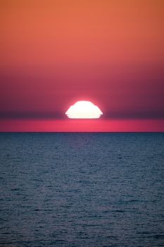 A breathtaking sunset over the ocean, showcasing vivid colors and serene beauty.