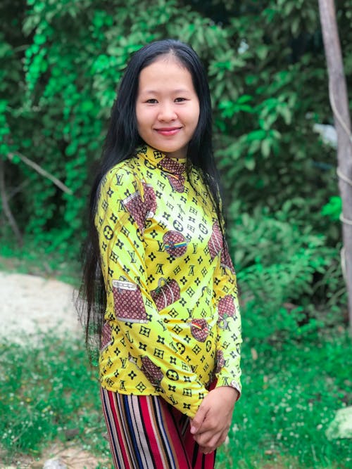 A Woman in Yellow Printed Dress Smiling