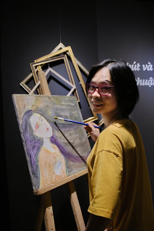 Young Woman in Yellow Shirt Doing Canvas Painting