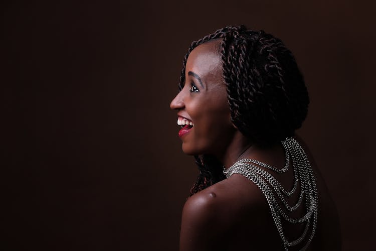 Woman In Braids Wearing Silver Necklaces