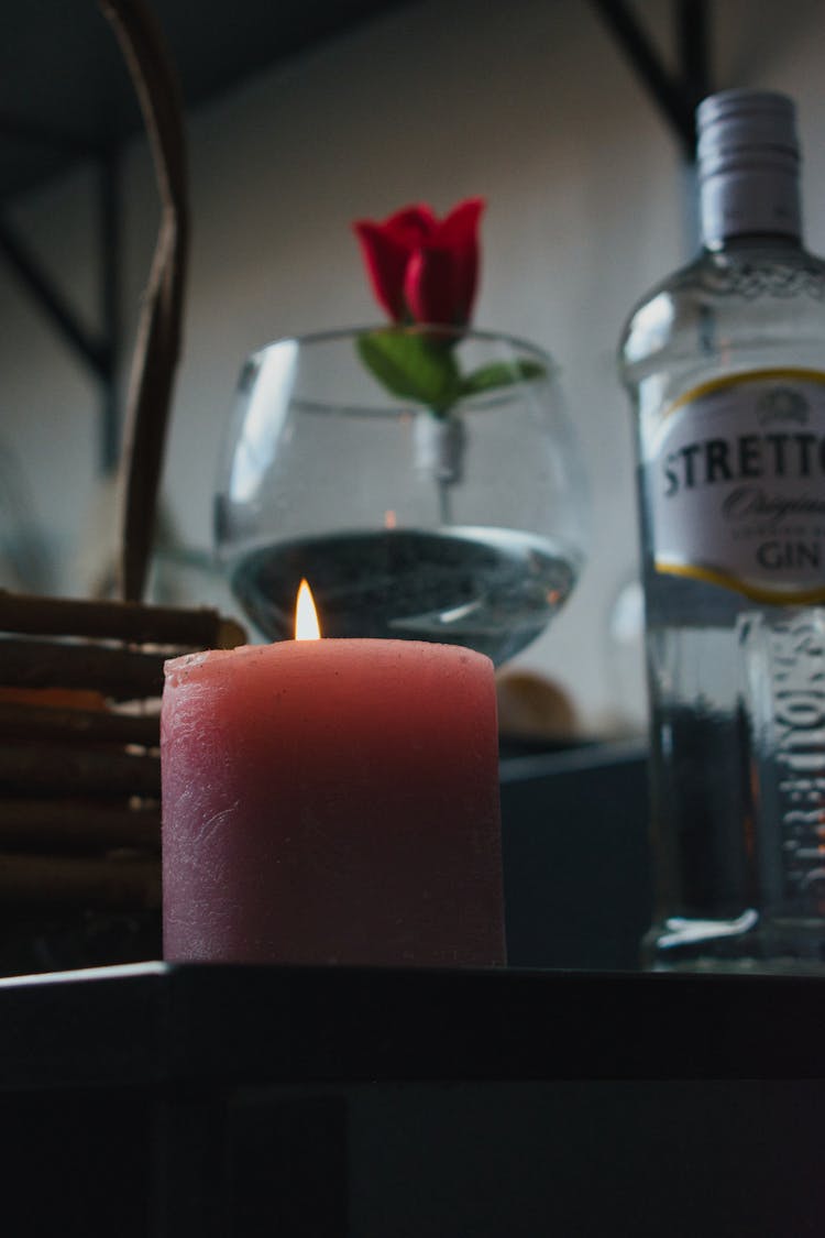 Candle And Alcohol In Glass On Table