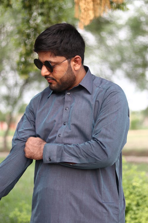 A Man in Gray Long Sleeves Wearing Sunglasses