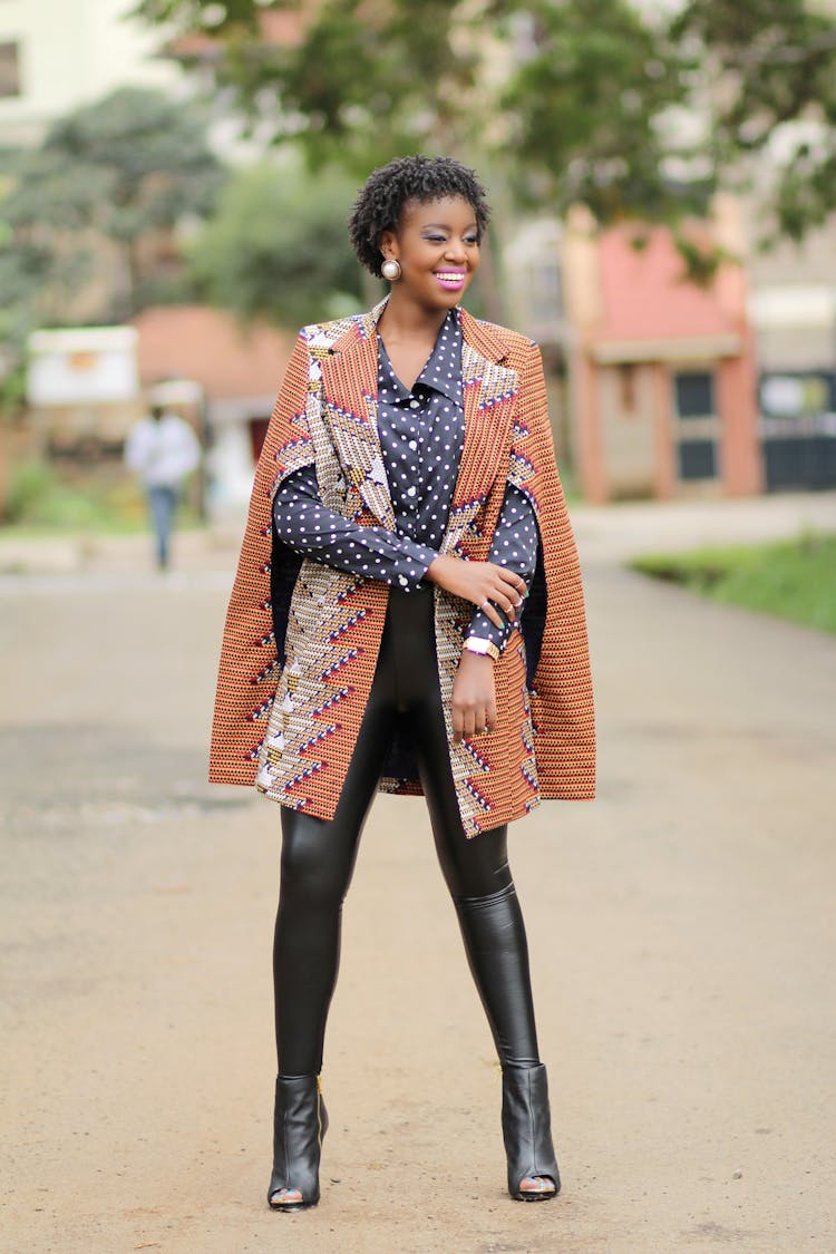 Model In Dotted Blouse And Patterned Coat