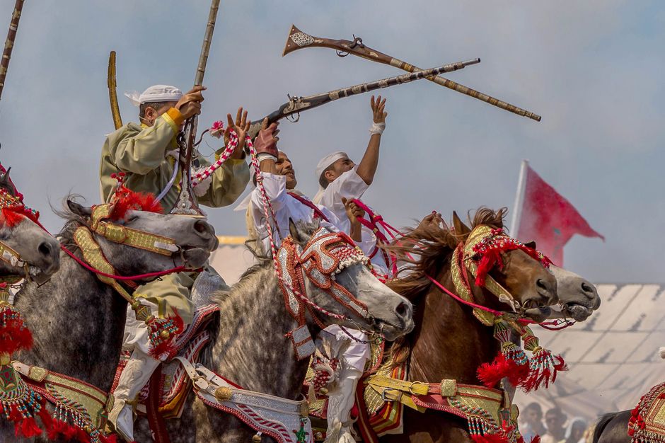 Vibrant display of Moroccan horsemen in traditional Fantasia festival showcasing culture and horsemanship.