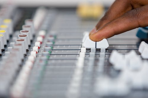 Close-up of Man Hand on Sound Mixer