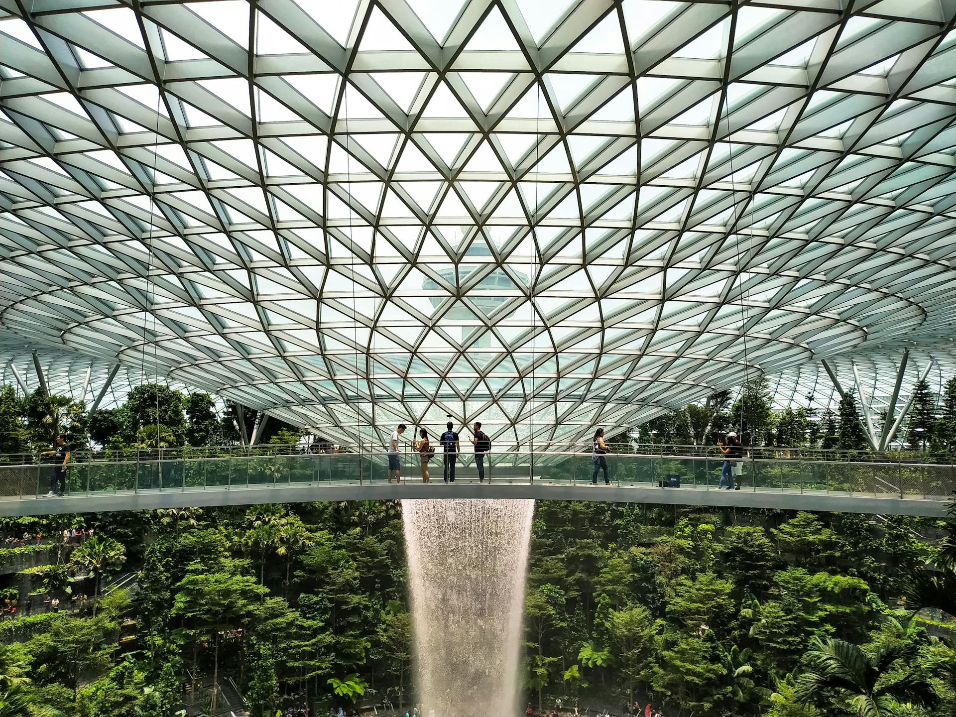 Explore the breathtaking interior design of Jewel Changi Airport with its iconic waterfall and lush greenery.