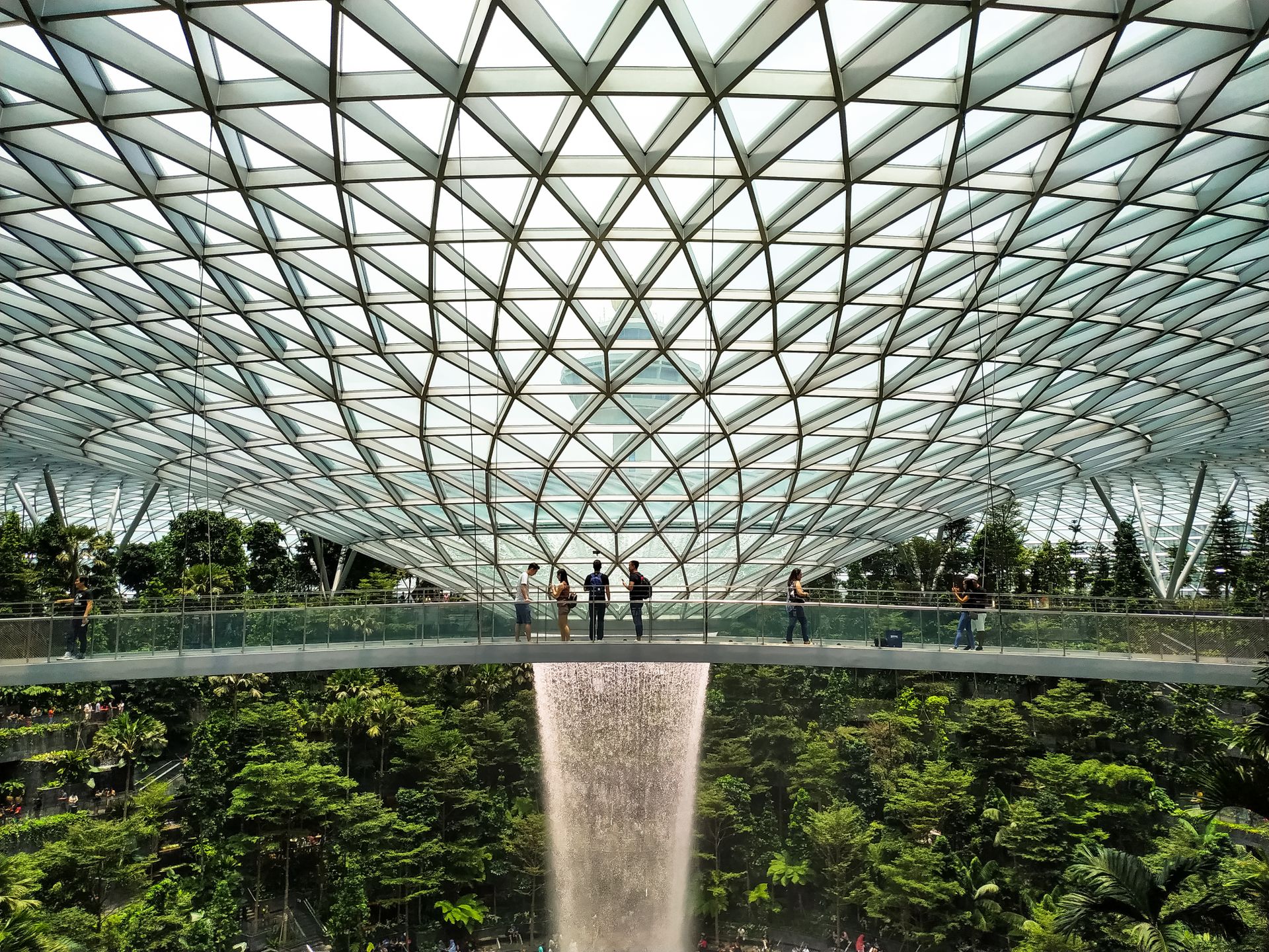 Explore the breathtaking interior design of Jewel Changi Airport with its iconic waterfall and lush greenery.