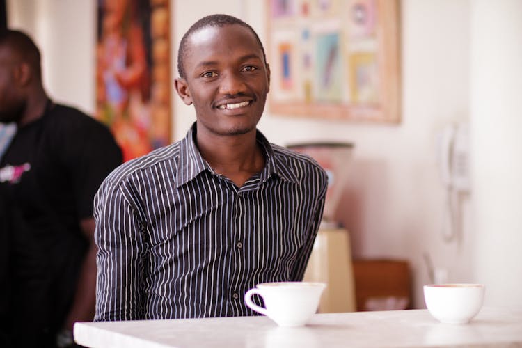 Man With Coffee Cup At Cafe