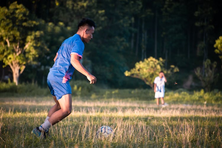 Man In Blue Jersey Playing Soccer