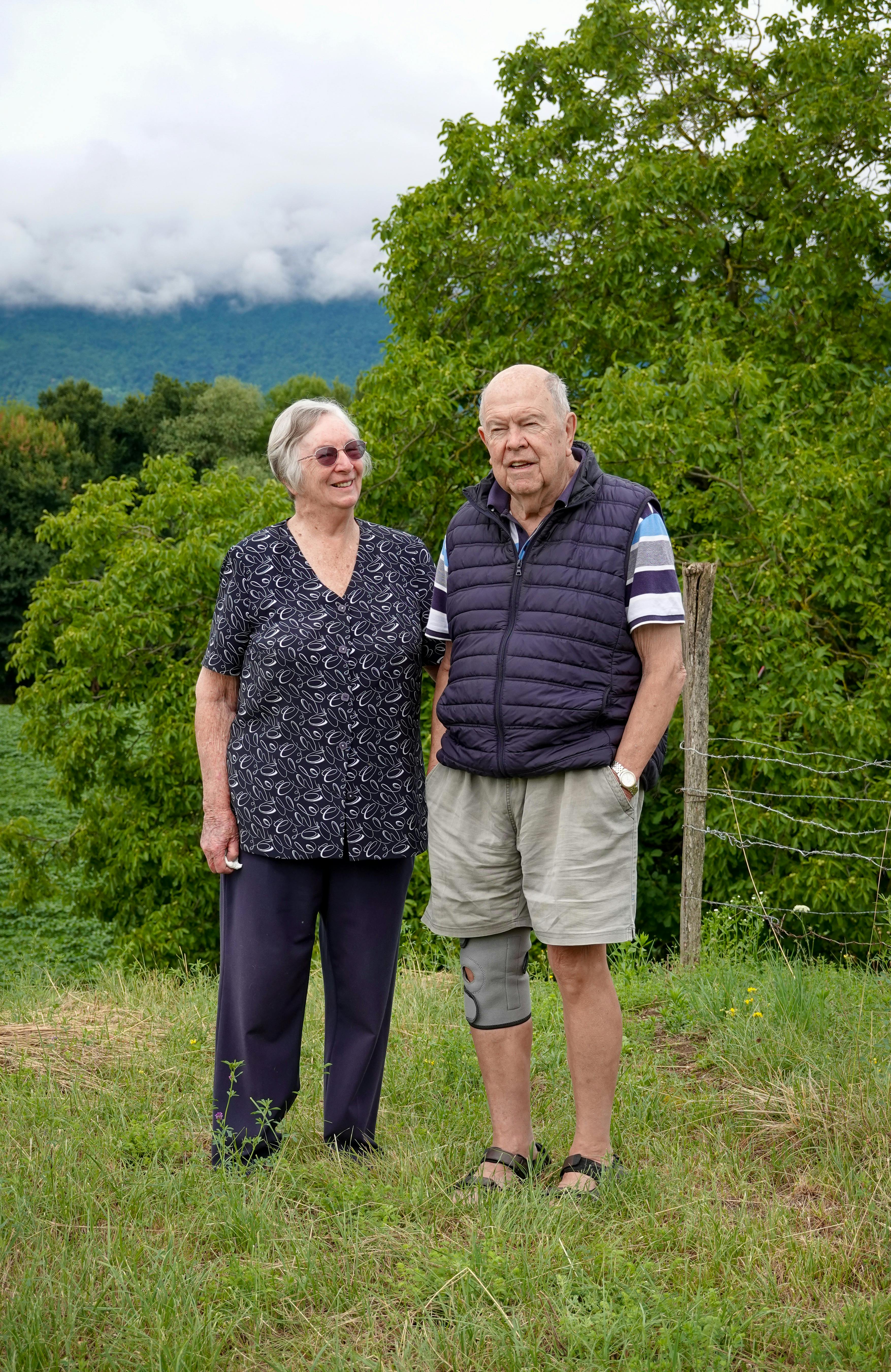Elderly couple enjoying a scenic outdoor setting together.