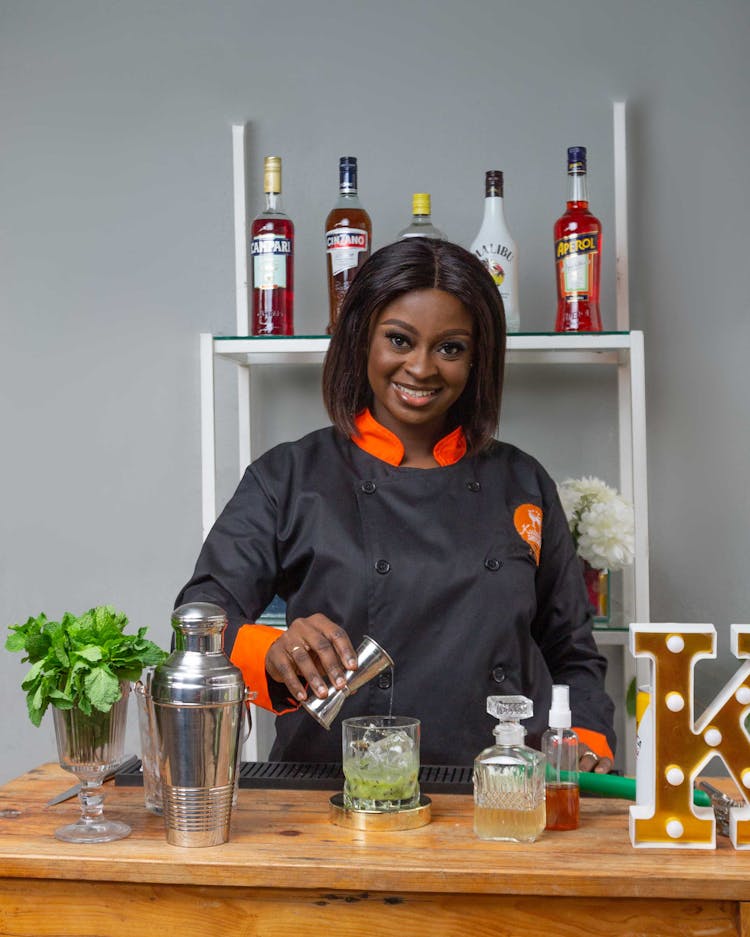 Woman Mixing Drink On A Bar Counter