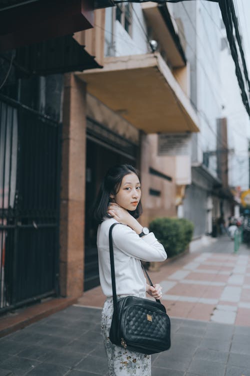 Young Woman Standing in a City Street