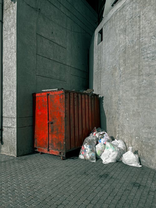 Free Metal Trash Bin on the Side of the Street Stock Photo