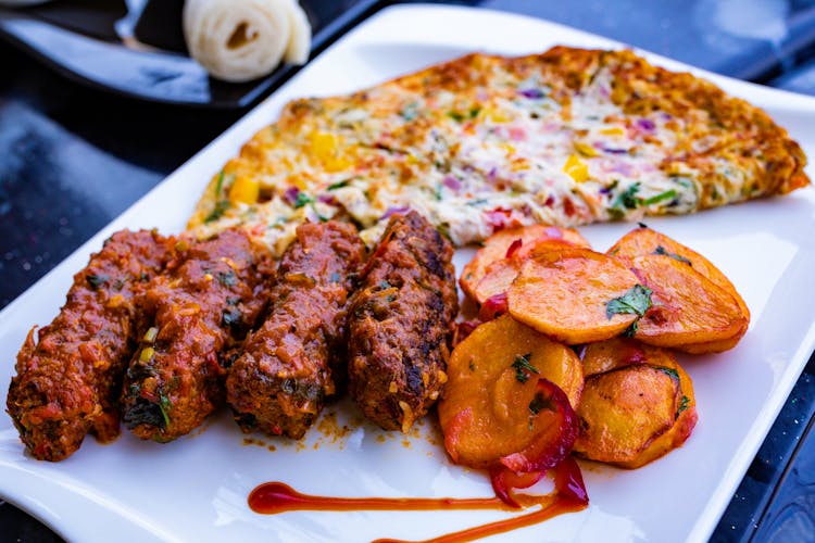 Pizza And Meat Kebabs On A Plate 