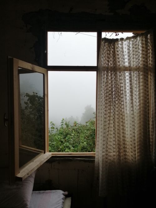 Free A serene view of a misty landscape through an open window in Giresun, Türkiye. Stock Photo