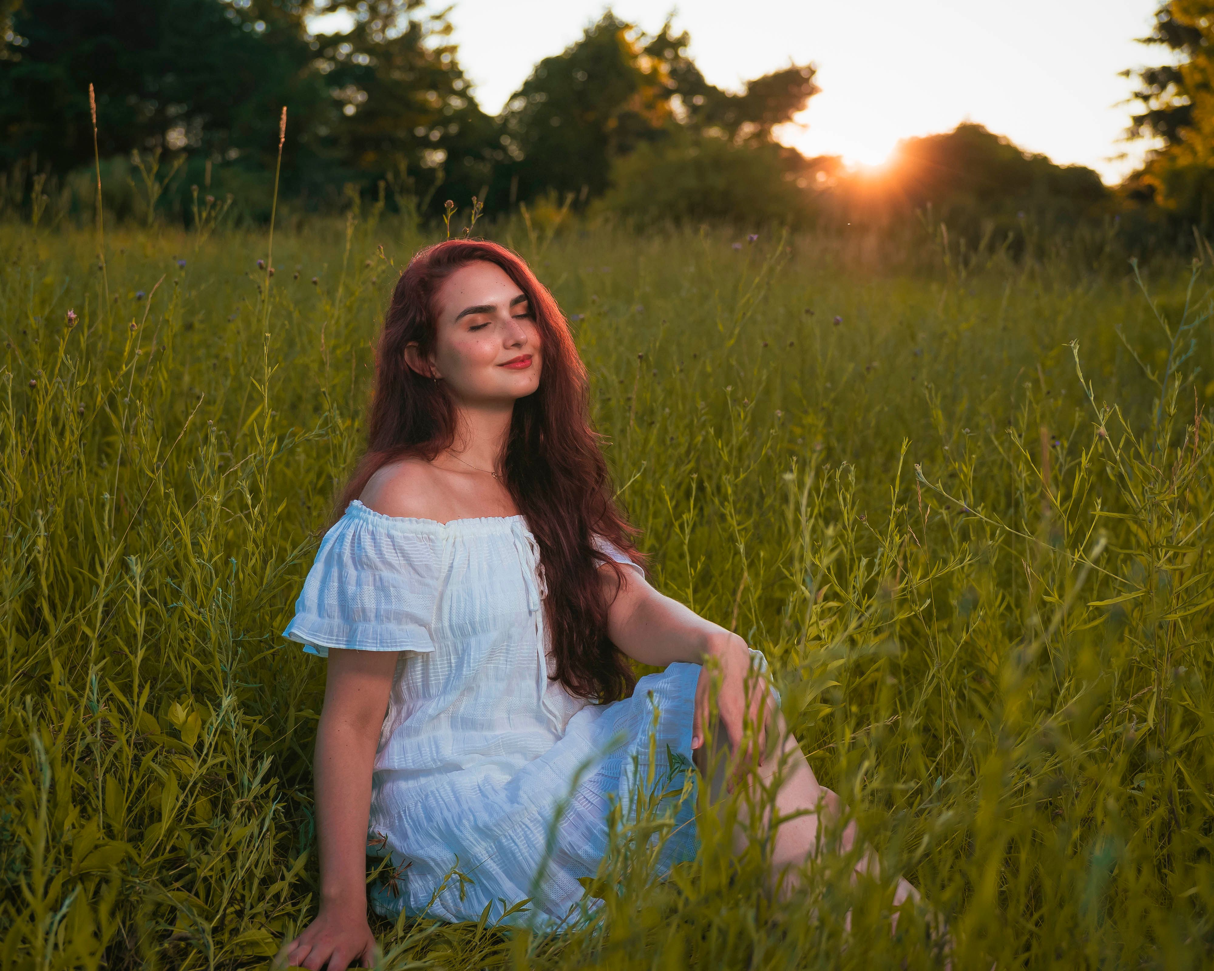 Woman in Traditional Dress Sitting on Grass · Free Stock Photo