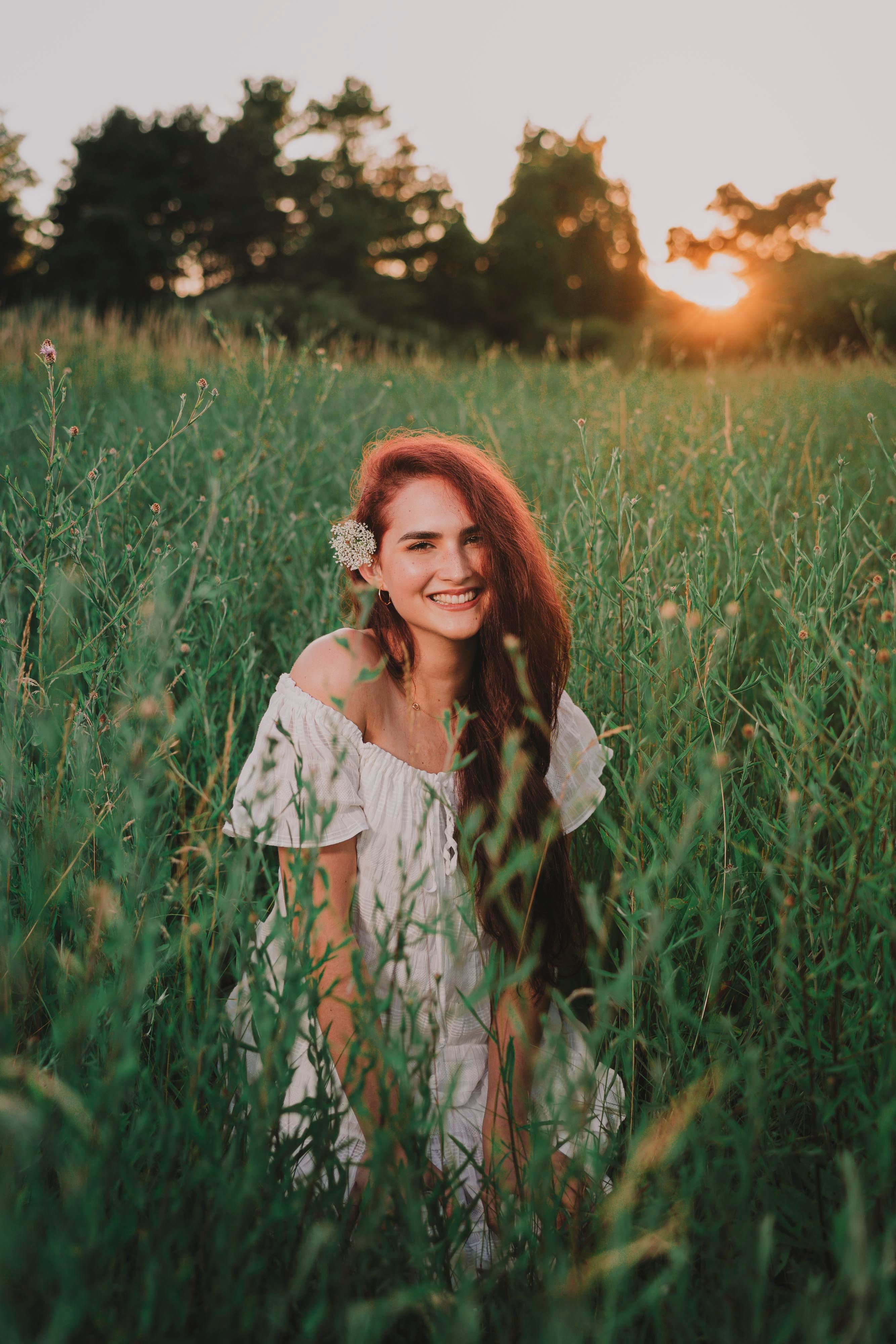Woman in White Dress Sitting on Grass Field · Free Stock Photo