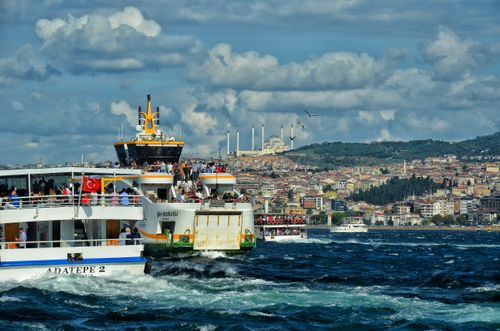 Free Bustling ferry on Bosphorus Strait, Istanbul with a stunning city backdrop, perfect for travel enthusiasts. Stock Photo