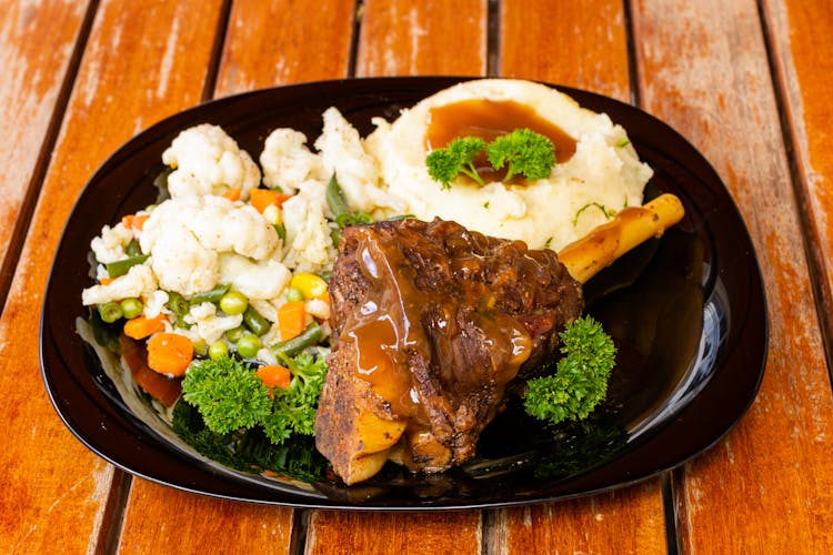 Cooked Steak On A Black Plate