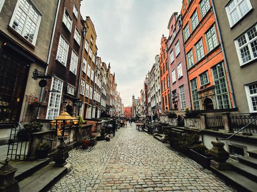 Free Picturesque view of historic Mariacka Street in Gdańsk, Poland, lined with colorful buildings. Stock Photo