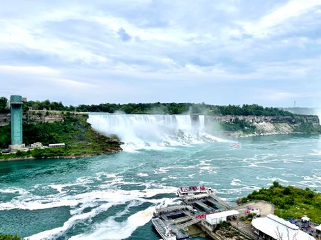A breathtaking aerial view of Niagara Falls showcasing its powerful water flow and mist.