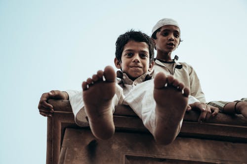 Free Kids Sitting on the Roof Stock Photo