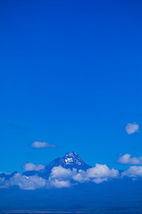 Tall Mountain Surrounded by White Clouds 