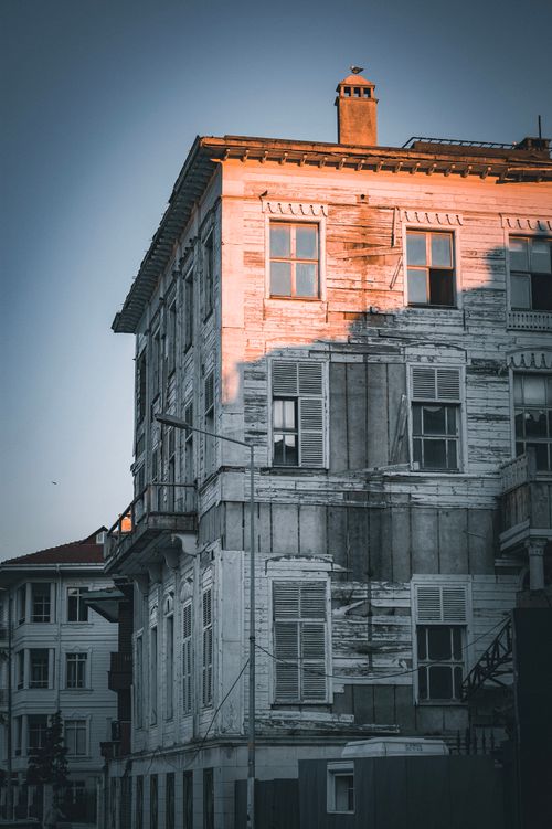 Free A historic wooden building in Istanbul, illuminated by the warm twilight sun, showcasing aged architecture. Stock Photo