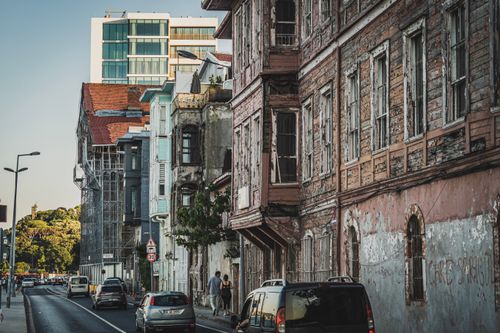Free Street in Istanbul featuring aged buildings and modern architecture, with light traffic. Stock Photo