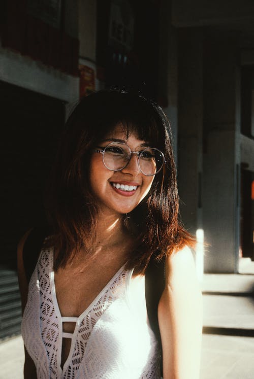 Beautiful Woman in White Top Wearing Eyeglasses