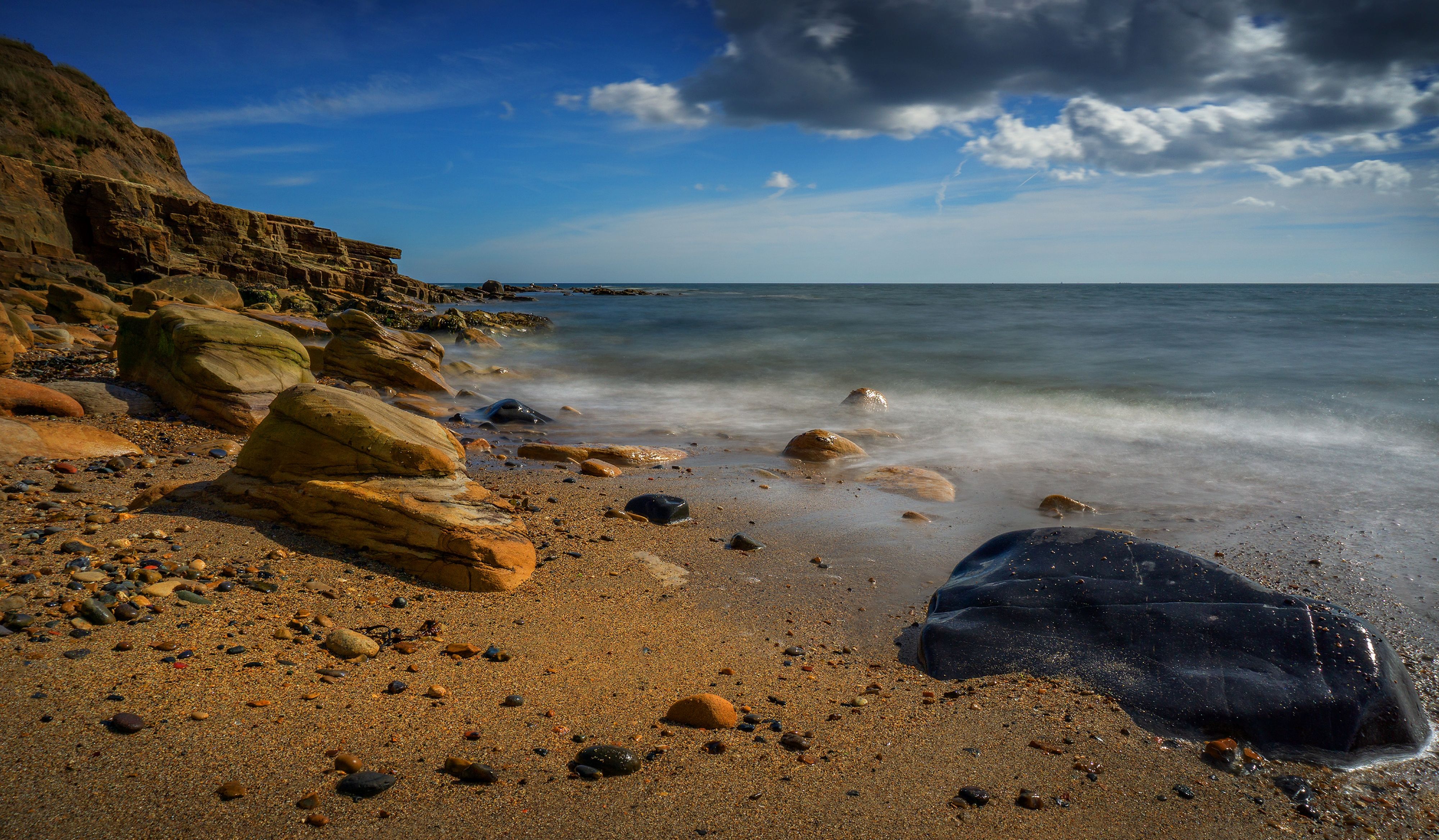 Brown Rock Formation on the Shore of a Sea · Free Stock Photo
