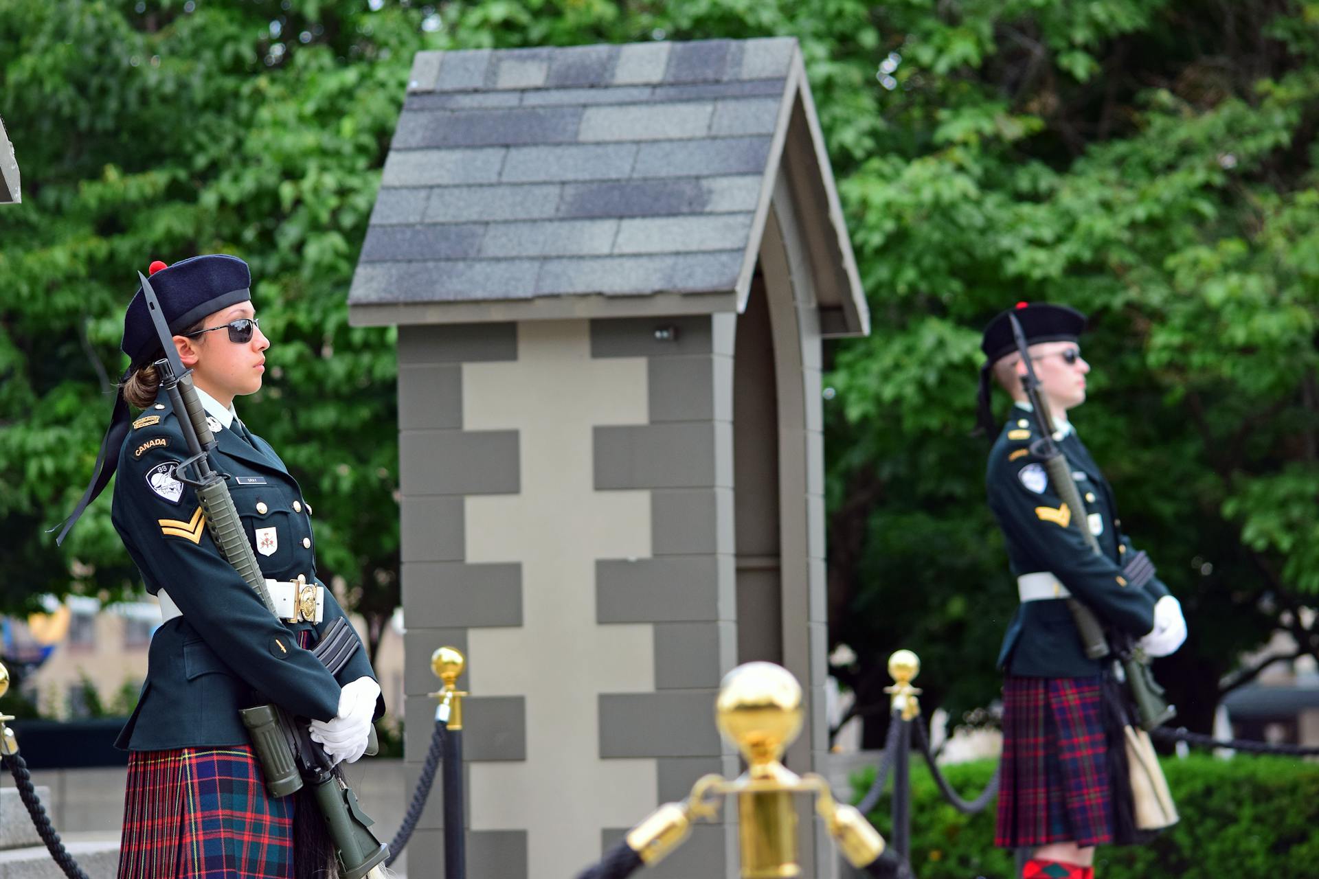 Canadian Officers in Uniforms Standing next to a Hut near a Street