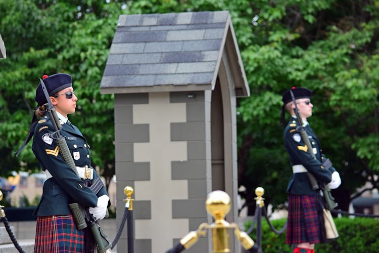 Canadian Officers In Uniforms Standing Next To A Hut Near A Street 