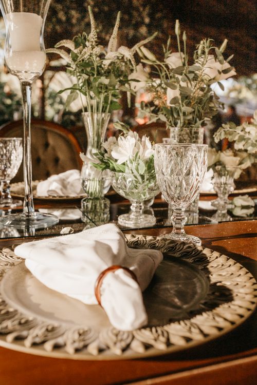 Free A beautifully arranged dining table with glassware, candles, and floral decorations, perfect for special occasions. Stock Photo