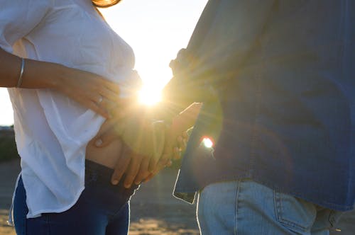 Man Touching Stomach of Pregnant Woman