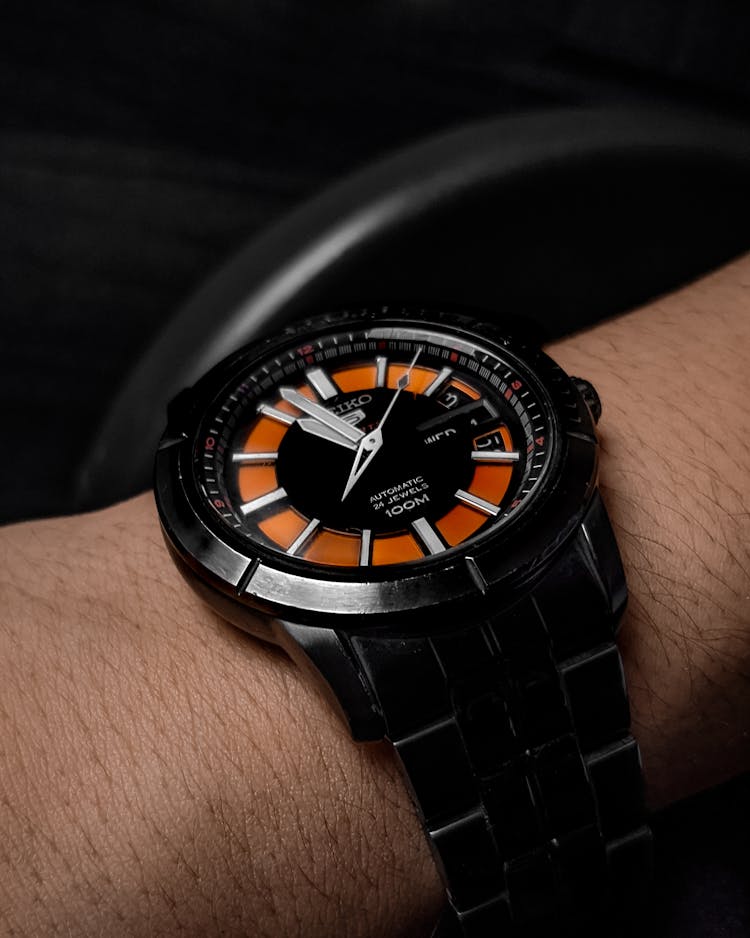 Person Wearing A Black Seiko Watch