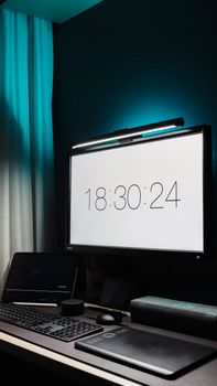Contemporary desk setup featuring a digital clock on a monitor in a sleek office environment.